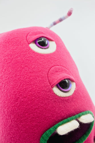 bright pink monster with two eyes and pocket mouth