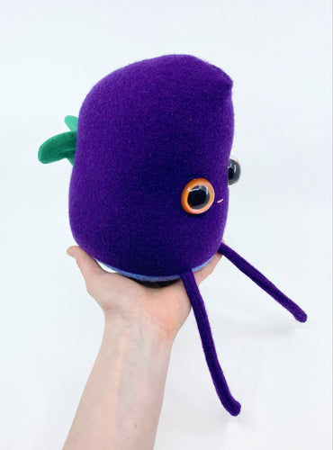 purple stuffed butterfly monster with green wings